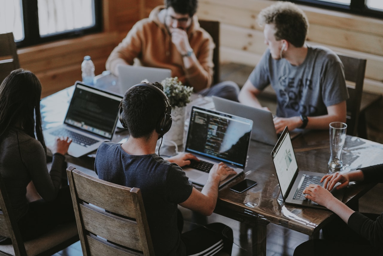 Remote professionals working at laptops - Pakistani remote staff for Romania